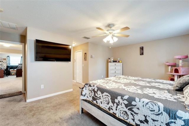 carpeted bedroom featuring ceiling fan and a closet