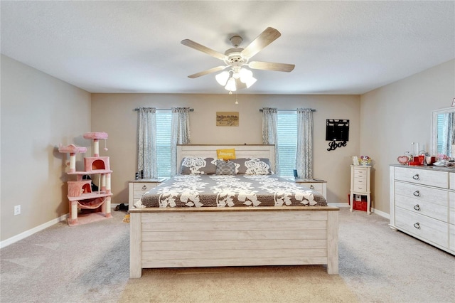 bedroom featuring light colored carpet and ceiling fan