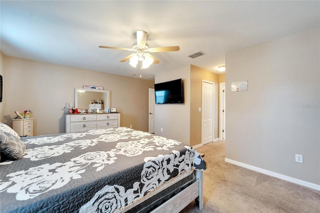 carpeted bedroom featuring ceiling fan and a closet