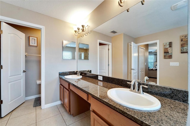 bathroom featuring tile patterned flooring, vanity, and a textured ceiling