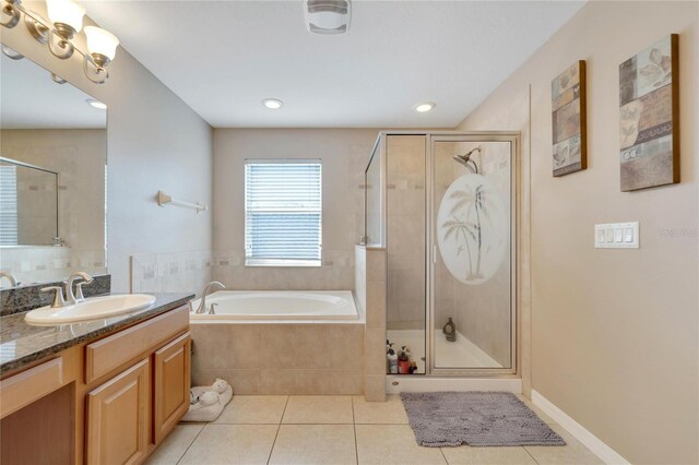 bathroom with tile patterned flooring, vanity, and separate shower and tub