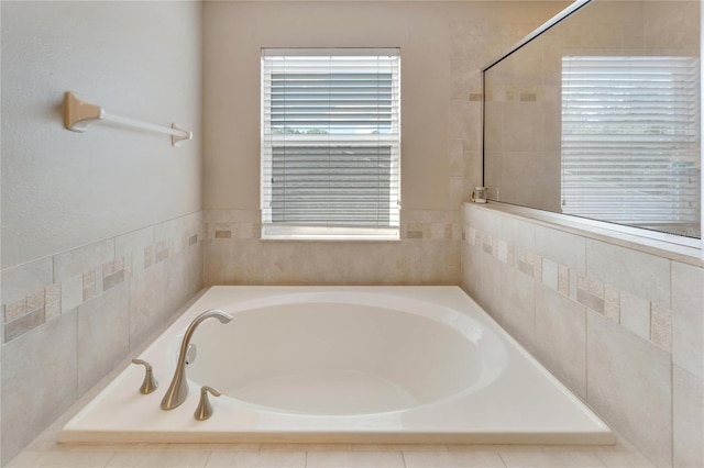 bathroom featuring tiled tub