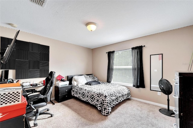 bedroom with a textured ceiling and carpet flooring