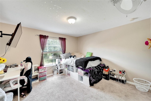 bedroom with a textured ceiling and carpet floors