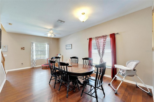 dining room with a healthy amount of sunlight, ceiling fan, and dark hardwood / wood-style floors