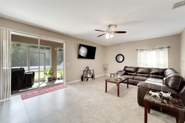 living room with ceiling fan and plenty of natural light