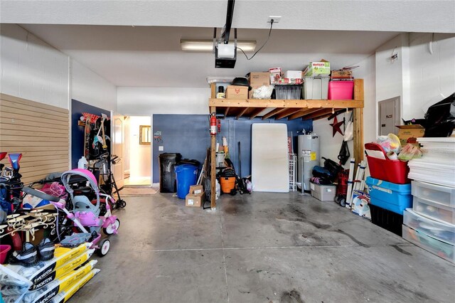 garage with a garage door opener, water heater, and electric panel