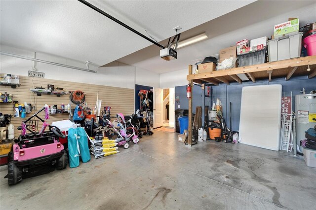 garage with gas water heater and a garage door opener