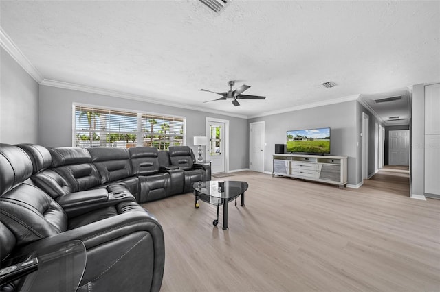 living room featuring visible vents, baseboards, ceiling fan, light wood-style flooring, and a textured ceiling