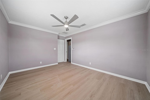 spare room featuring visible vents, light wood-style floors, ceiling fan, and ornamental molding