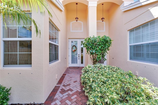 entrance to property with french doors and stucco siding