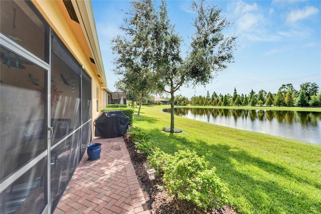 view of yard featuring a water view and a patio area