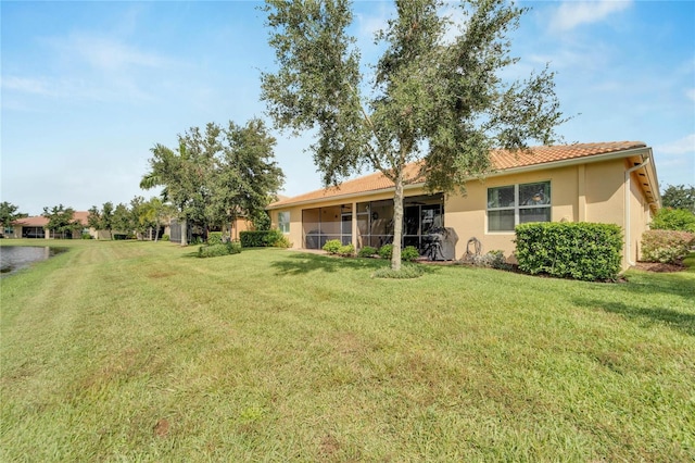 rear view of property featuring a yard