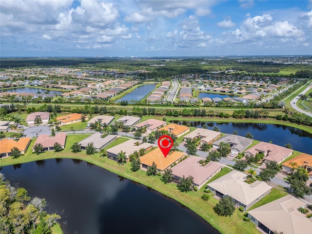 birds eye view of property featuring a water view and a residential view