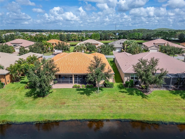 drone / aerial view with a water view and a residential view