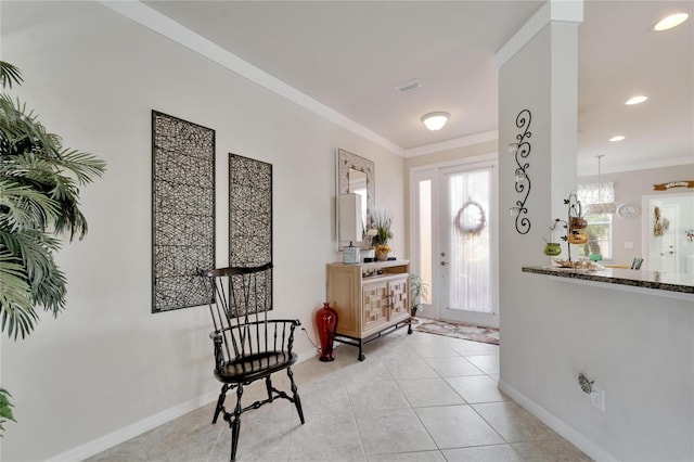 foyer featuring ornamental molding, a chandelier, and light tile patterned floors