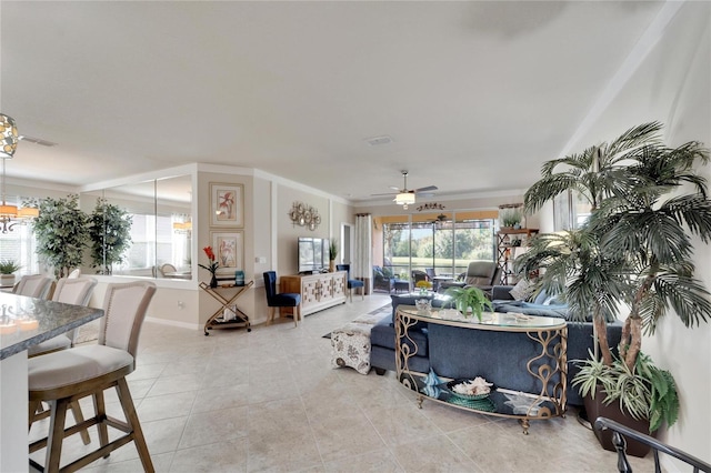 tiled living room featuring ceiling fan with notable chandelier, plenty of natural light, and crown molding