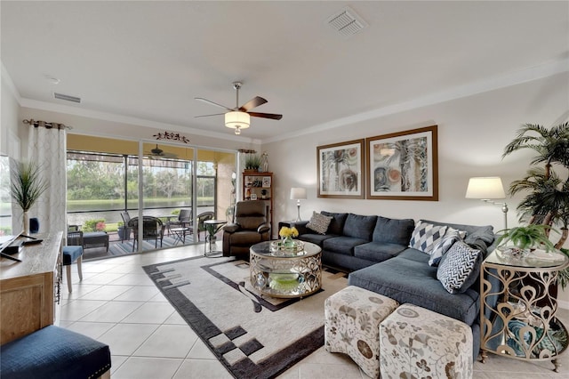 living area featuring ceiling fan, visible vents, ornamental molding, and light tile patterned flooring