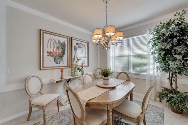 dining room with a chandelier, baseboards, and light tile patterned floors