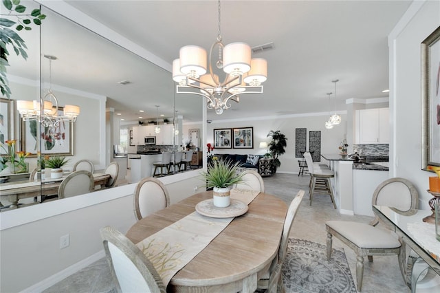 dining area with a chandelier and ornamental molding