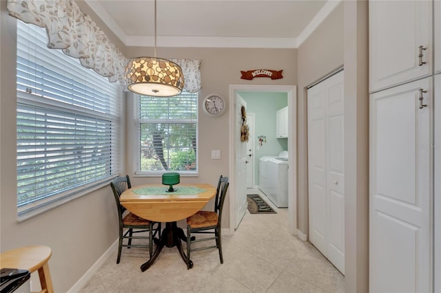 dining space with light tile patterned flooring, washer and clothes dryer, and ornamental molding