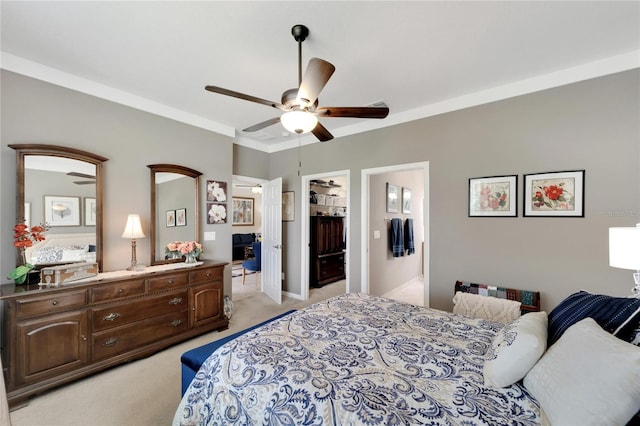 bedroom with crown molding, a closet, light colored carpet, a spacious closet, and a ceiling fan