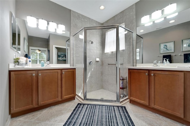 full bath featuring a shower stall, two vanities, and a sink