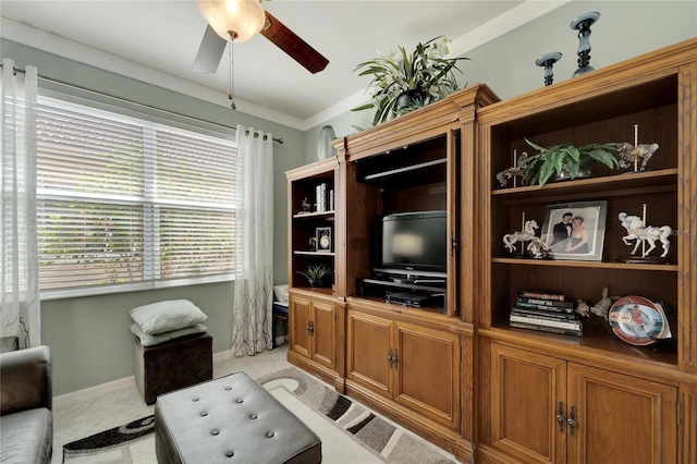 living area featuring light carpet, crown molding, baseboards, and a ceiling fan