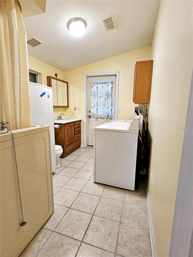 laundry area featuring laundry area, a sink, hookup for a washing machine, and visible vents