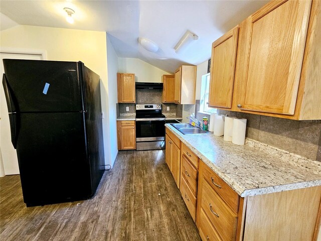 kitchen featuring a sink, freestanding refrigerator, vaulted ceiling, and stainless steel range with electric stovetop