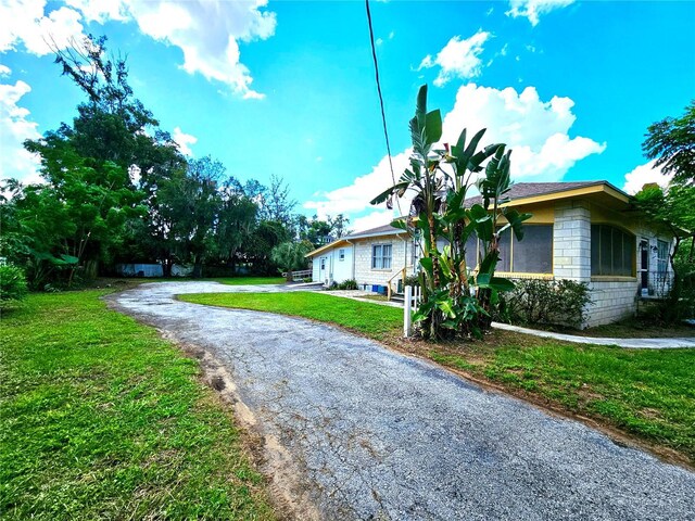 view of home's exterior featuring a yard and concrete block siding