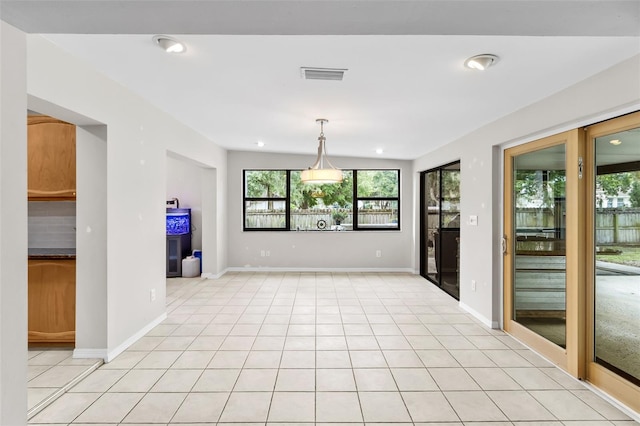 spare room featuring light tile patterned floors