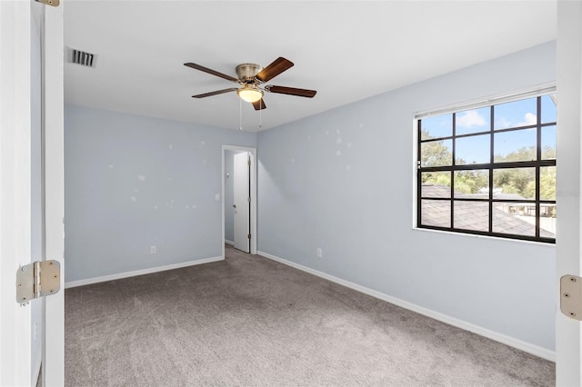 spare room with ceiling fan and carpet flooring