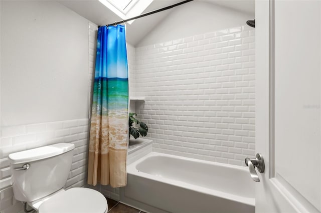 bathroom with toilet, tile patterned floors, lofted ceiling with skylight, and shower / tub combo