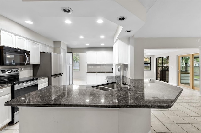 kitchen with appliances with stainless steel finishes, white cabinets, tasteful backsplash, and sink