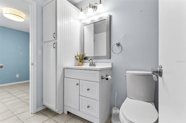 bathroom featuring toilet, tile patterned floors, and vanity