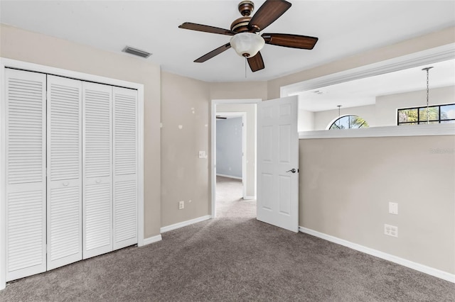 unfurnished bedroom with ceiling fan, a closet, and carpet floors