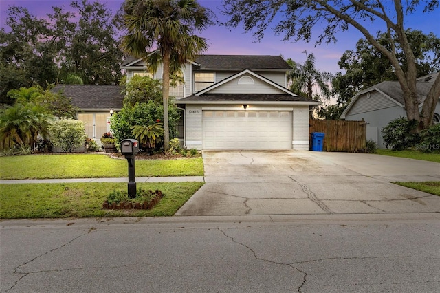 view of front property featuring a garage and a lawn