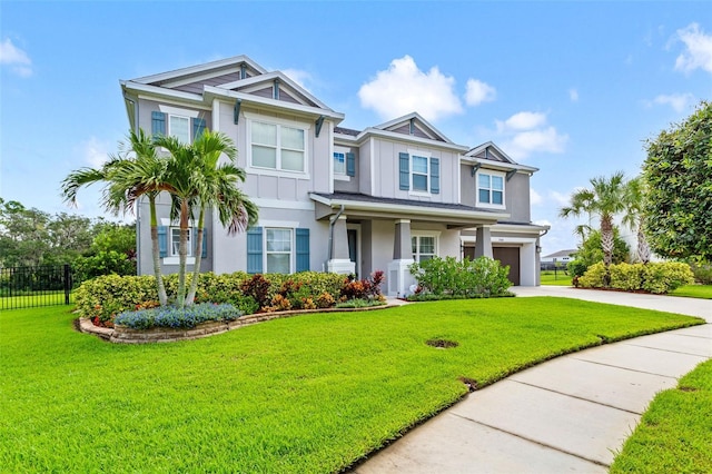 view of front of property with a front yard and a garage