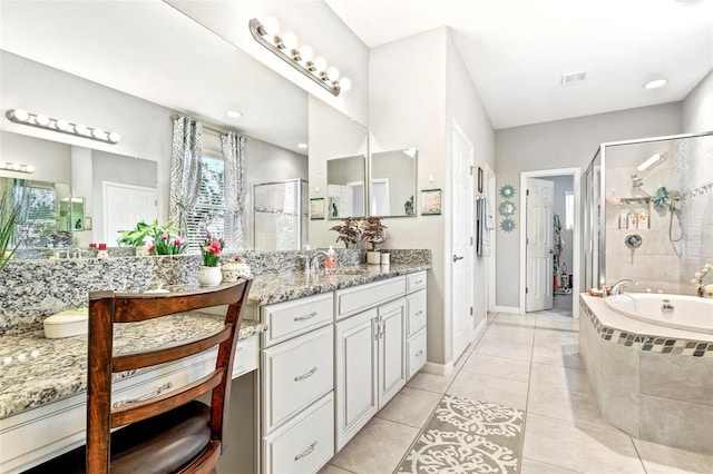 bathroom with tile patterned floors, vanity, and separate shower and tub