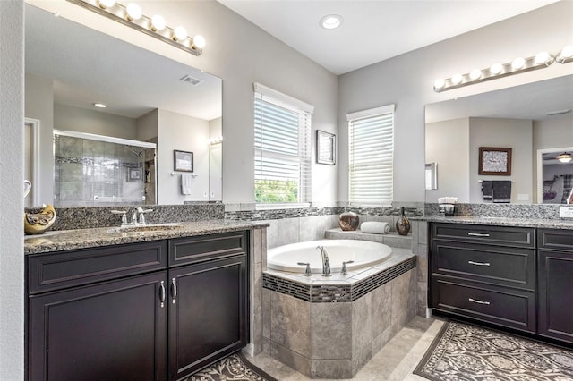 bathroom with shower with separate bathtub, tile patterned flooring, and vanity