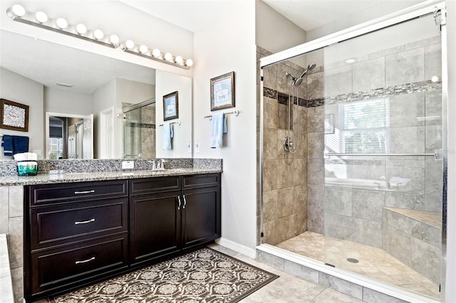 bathroom featuring tile patterned floors, walk in shower, and vanity