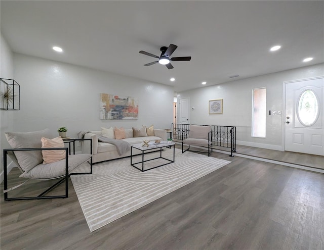 living room featuring hardwood / wood-style flooring and ceiling fan