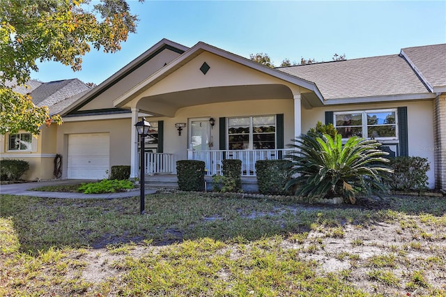 ranch-style home featuring covered porch and a garage