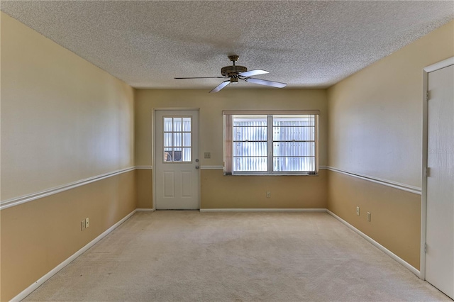 doorway to outside featuring light carpet, a textured ceiling, and ceiling fan