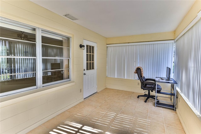 tiled office space with ceiling fan