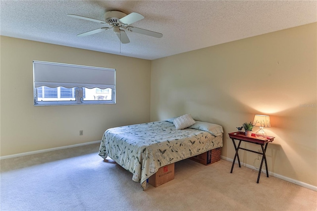 carpeted bedroom with ceiling fan and a textured ceiling