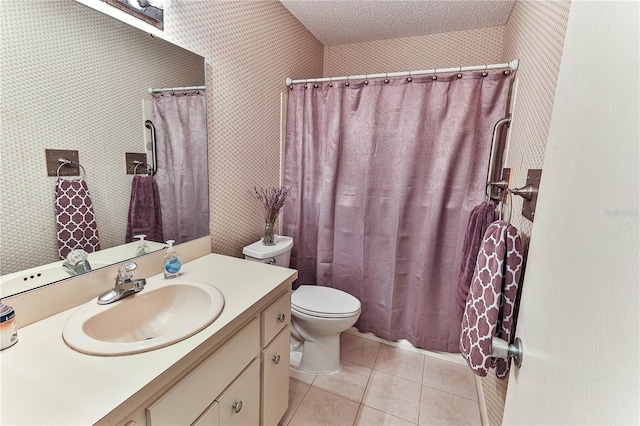 bathroom featuring vanity, a textured ceiling, tile patterned floors, and toilet