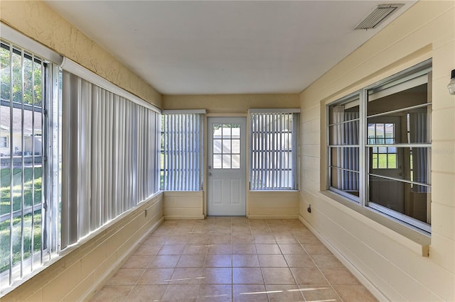 unfurnished sunroom featuring a wealth of natural light