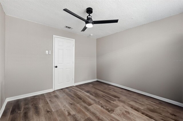 spare room with ceiling fan, hardwood / wood-style flooring, and a textured ceiling